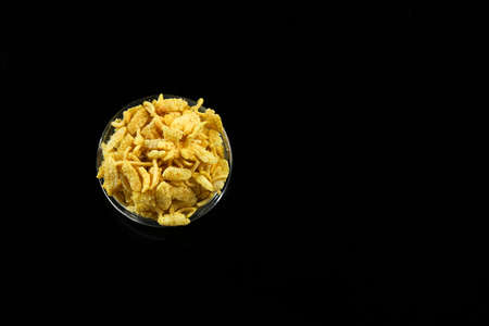 Indian snacks in bowl on dark backgroundの写真素材