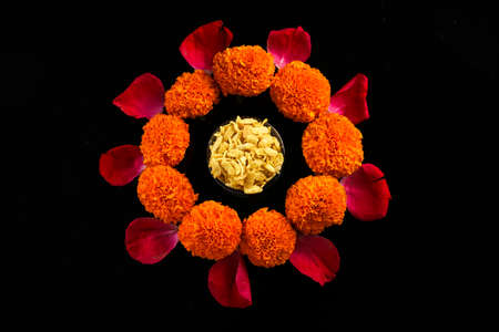 Diwali Rangoli or design made using Indian snacks , lamp and flowersの写真素材