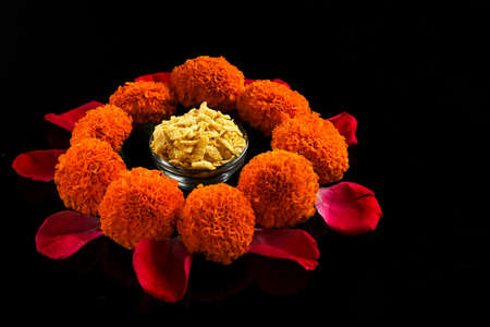 Diwali Rangoli or design made using Indian snacks , lamp and flowersの写真素材