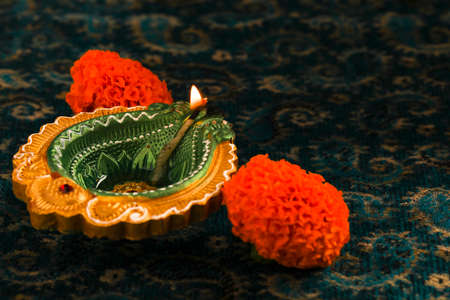 Indian Festival Diwali , oil lamp and flower on dark backgroundの写真素材