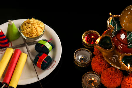 fire crackers,lamp and flower on dark background , Indian festival Diwaliの写真素材