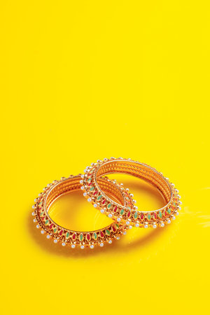 Gold Loan concept : Gold jewelry on yellow background