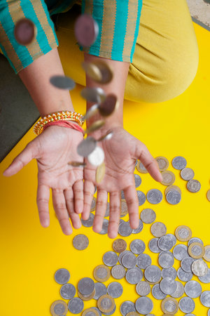 women bouncing indian rupees coin in hand