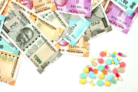 Pile of pharmaceutical drug,  medicine pills and indian money, cost of healthcare and medical...