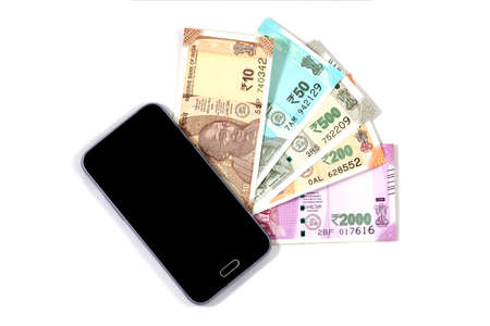 Mobile smart phone and indian rupee notes, digital money,fin-tech,money making online conceptsの写真素材