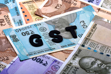 GST concept,GST alphabet on money background,business and financial concept idea,Indian Currency,...