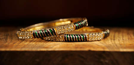 Diamond and meenakari bangles on wooden background,  Indian Traditional jewelryの写真素材