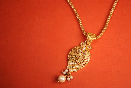 Gold and pearl pendant with chain, Indian Traditional jewelryの写真素材