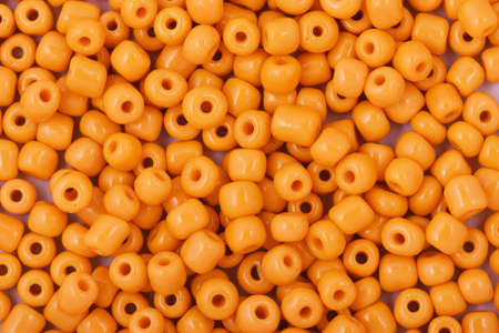 Yellow Beads on the white background. Background or texture of beads. Close up, macro,It is used in finishing fashion clothes. make bead necklace or string of beads for woman of fashion.の写真素材