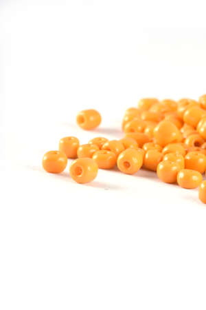 Close up of yellow Beads on the white background. Background or texture of beads. macro,It is used in finishing fashion clothes. make bead necklace or string of beads for woman of fashion.の写真素材
