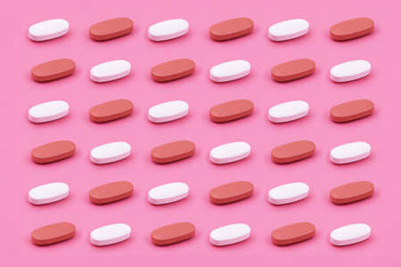 Oval shape Pharmaceutical medicine tablet on a pink background,Medicine creative concepts. Minimal...