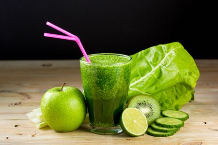 Green vegetable detox juice on wood tableの写真素材
