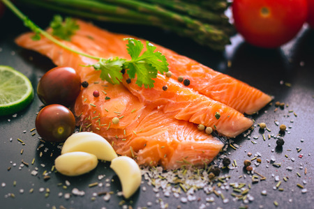 Delicious portion of fresh salmon fillet with salt and pepperの写真素材