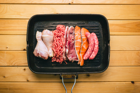 Types of proteins placed in a pan. Chicken, meat, pig, fishの写真素材