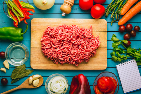 Frame of various vegetables and ingredients to cook ground beef