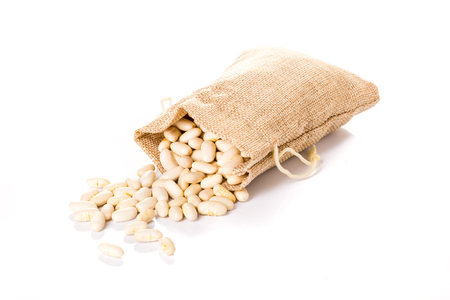 bag with uncooked white beans, vegetarian food on white backgroundの写真素材