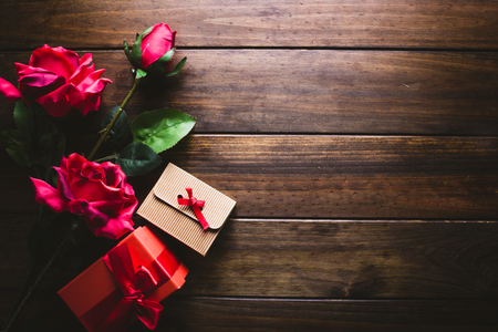 Valentine's gifts on the left side of the photograph there are roses and gift boxes with a negative space on the right for logos or text.の写真素材