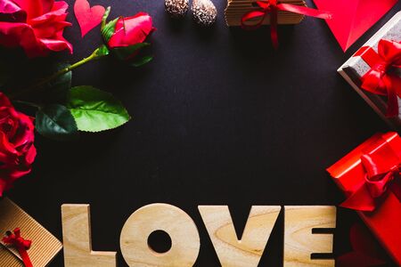 Frame with different gifts referring to Valentine's Day on a wooden background.の写真素材