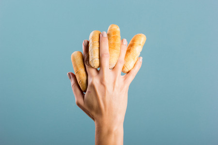 woman's hand holding cheese fingersの写真素材
