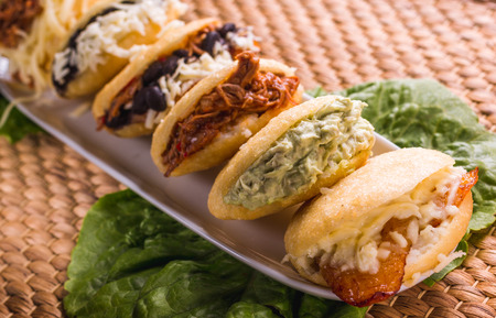 Different types of arepas, meat, black beans, cheese, fried plantain, typical South American foodの写真素材