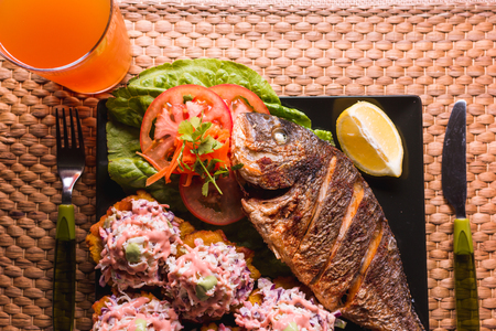 fried fish with fried plantain and salad, beach food in Venezuelaの写真素材