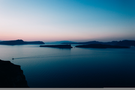 Beautiful sunset in the caldera of santorini greece, on the left side of the frame you can see a...