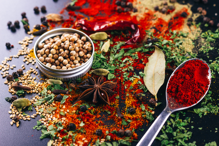 Disaster of spices and condiments for cooking, on a dark table, restaurant conceptの写真素材