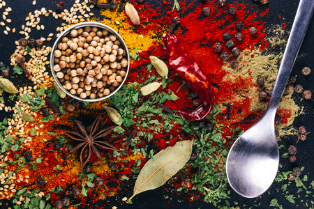 Disaster of spices and condiments for cooking, on a dark table, restaurant conceptの写真素材