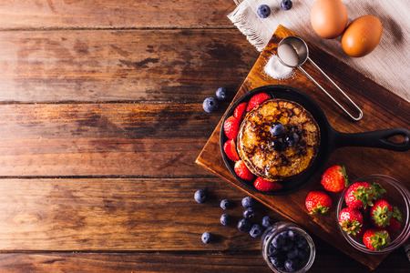 Top View of Delicious breakfast of pancakes served with strawberries and blueberriesの写真素材