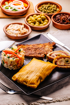 Christmas dish in Venezuela, hallaca, ham bread, salad and porkの写真素材