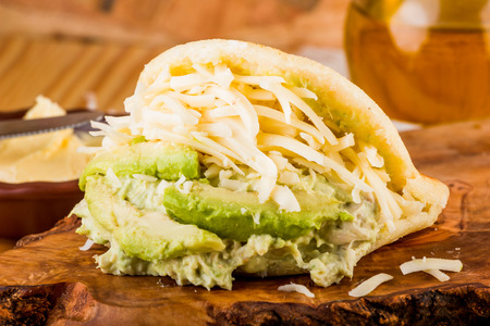 Typical Latin American food, arepa for breakfast with cheese, avocado and chickenの写真素材