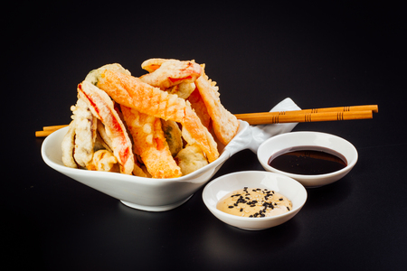 Delicious tempura vegetables ideal for vegetarians on a black backgroundの写真素材