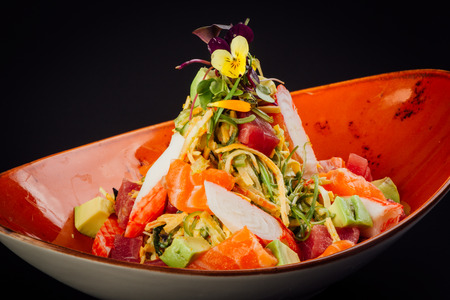 Salad with surimi, avocado, salmon and tuna.の写真素材