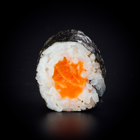 Salmon maki sushi rolls on a black background, japanese foodの写真素材
