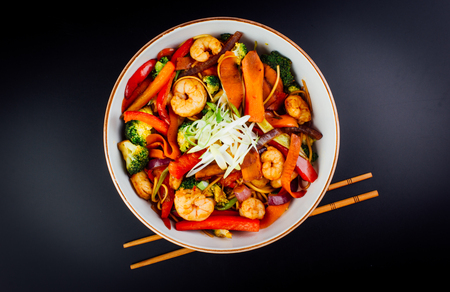 Vegetables and shrimps in  bowl. black background. japanese foodの写真素材