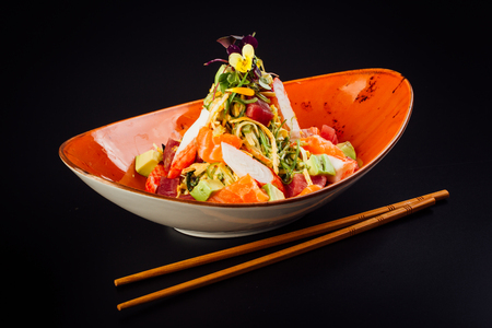 Salad with surimi, avocado, salmon and tuna.の写真素材