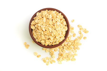Top view of Bowl full of flaked oats on a white backgroundの写真素材