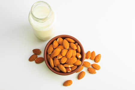 Top view of Milk and bowl of almonds isolated on a white backgroundの写真素材