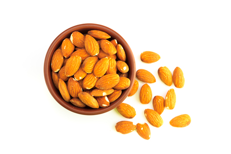 Top view of bowl full of almonds and isolated on a white backgroundの写真素材
