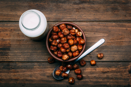 Hazelnut milk isolated on a wood background, vegan milkの写真素材