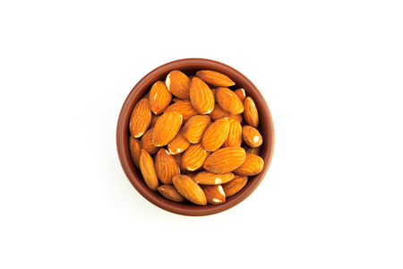 Top view of bowl full of almonds and isolated on a white backgroundの写真素材