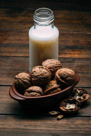 Walnuts milk on a wood backgroundの写真素材