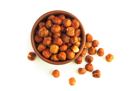 bowl full of hazelnuts isolated on a white backgroundの写真素材