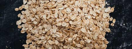 Top view of a oat flakes on a black background. healthy food concept.の写真素材