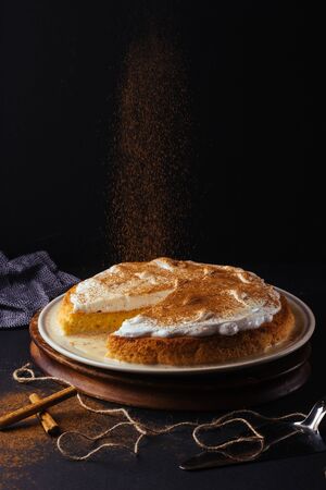 Homemade preparation of a three milk tart. The image is made on a dark background and rustic boards. Venezuelan cakeの写真素材