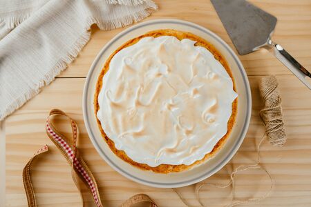 Top view of a delicious three milk cake on a pine wood background, typical Latin American dessertの写真素材