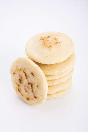 Stack of arepas made with corn flour on a white background, typical Latin American foodの写真素材