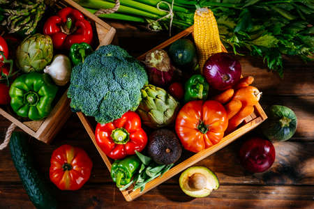 Top view of colorful fresh farm vegetables on a wooden table, balanced dietの写真素材