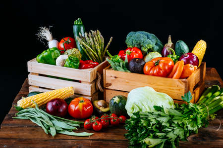 Boxes full of different types of healthy organic vegetables for a vegan dietの写真素材