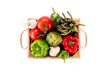 Box full of colorful fresh vegetables on white backgroundの写真素材